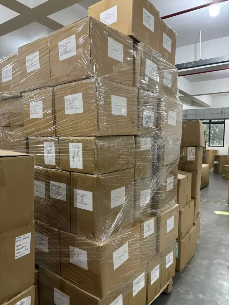 Finished party supply cartons stacked in the Damai warehouse